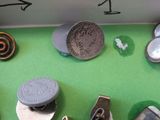 many different types of buttons on a green surface