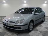 a picture of a silver car parked in a showroom