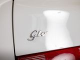 a close up of a white car with a cat on it ' s tail