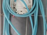 a white toilet with a blue hose attached to it