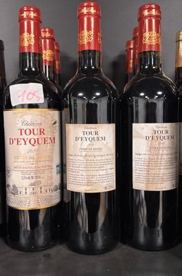several bottles of red wine are lined up on a shelf