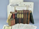 an assortment of old books and pamphlets on a table