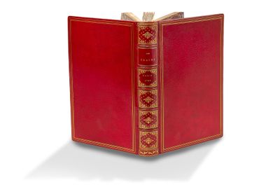 un vieux livre rouge aux tranches dorées et à la couverture rouge