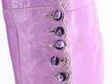purple boots with spikes on the side of them on a white background