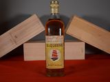 a bottle of liquor sitting on a table next to a wooden box