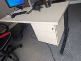 a desk with a computer monitor and a keyboard on it