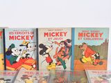 mickey and mickey mouse books are lined up on a table