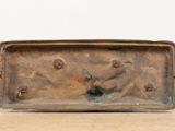 bronze sculpture of a man and a dog on a wooden surface