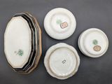 four pieces of porcelain are sitting on a table