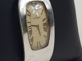 a small black bag with a silver clock on it