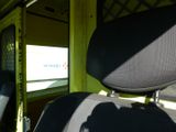 two seats in the back of a bus with the sun shining through the window