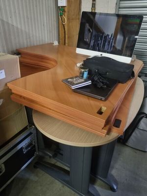 a laptop computer sitting on top of a wooden desk
