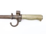 a close up of an old gun on a white surface
