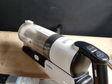 a vacuum that is sitting on a table next to a cell phone