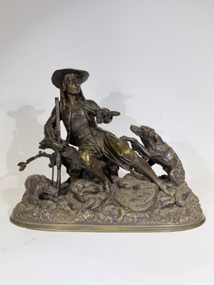 bronze statue of a man on a horse with a dog