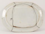 a white plate with a crack in the middle