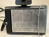 a small camera sitting on top of an old newspaper