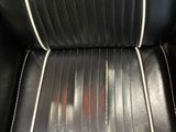black and white leather recliner with white stitching on the back