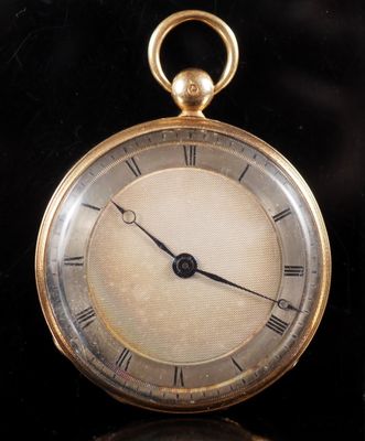 an old gold pocket watch with roman numerals on the face