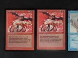 three cards with different designs on them on a black surface