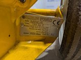 a close up of a yellow machine with a label on it