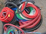 a pile of hoses sitting on the ground next to other hoses