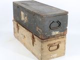 two old suitcases stacked on top of each other on a white surface