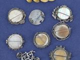 a close up of a bunch of brooches on a blue cloth