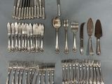 a lot of silver spoons and forks on the table