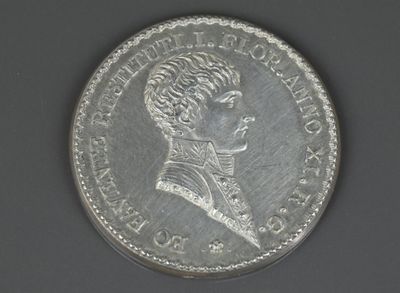gros plan d'une pièce de monnaie sur laquelle figure un visage de femme