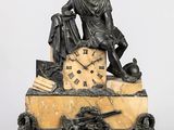 une statue d'un homme assis au sommet d'une horloge