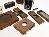 a lot of old cameras and other items on the table