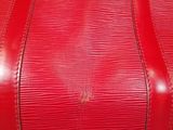 a red louis vuitton bag on a table