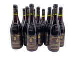 six bottles of wine are lined up on a white surface