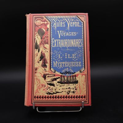 un vieux livre posé sur un support métallique