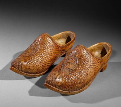 pair of leather shoes with a fish motif on the sole
