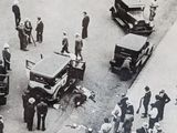 a large crowd of people standing around old cars and trucks