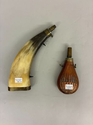 two pieces of horn and a bottle of wine on a table