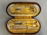a case that has a set of scissors and spoons inside of it