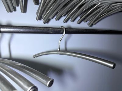 a bunch of metal tubes hanging on a rack