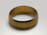 a close up of a gold ring on a white surface