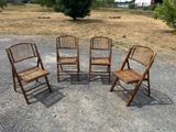 four wooden chairs are arranged in a circle on a gravel road