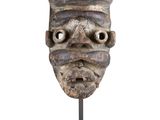 an image of a sculpture of a man ' s face on a stand