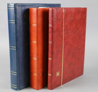 trois livres sont alignés les uns à côté des autres sur une surface grise
