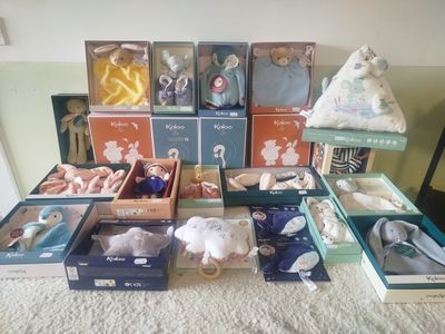 many different types of stuffed animals in boxes on the floor