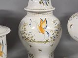 several different types of vases are displayed on a gray surface