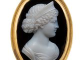 a close up of a black and white cameo of a woman