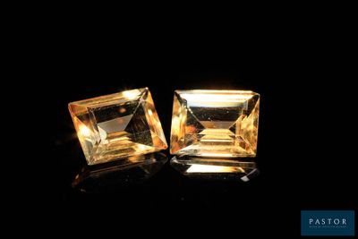 two square cut yellow sapphires on a black background