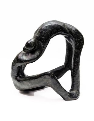 a black sculpture of a man and a woman holding each other