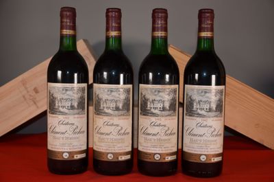 three bottles of red wine sit on a table next to a wooden box